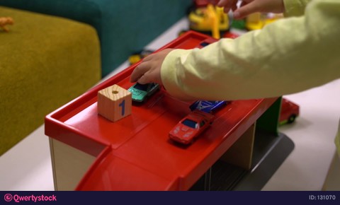 The boy's hands play cars in the parking lot indoors video 131070